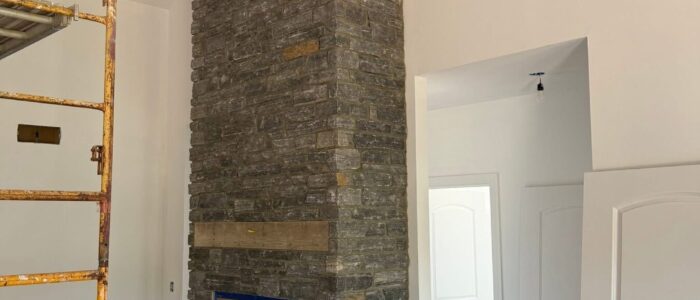 tall-gray-stone-fireplace-angle