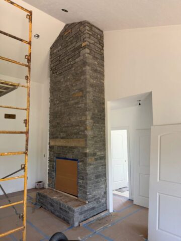 tall-gray-stone-fireplace-angle