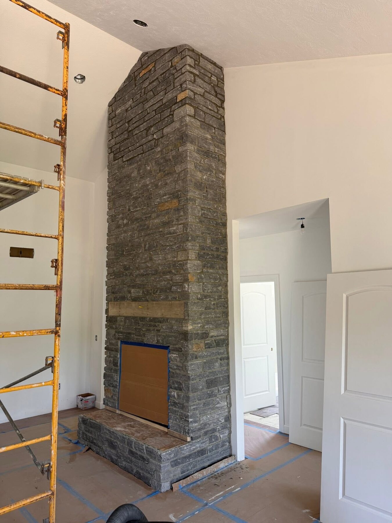 Tall gray stone fireplace