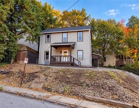 Renovated home at 300 Morton Ave, Butler, PA, with covered front porch and autumn trees